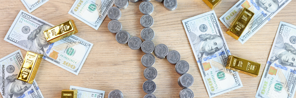 Coins in shape of dollar symbol and a lot of gold bars with US dollar bills on table, top view. Coins in shape of dollar symbol and a lot of gold bars with US dollar bills on table, top view.