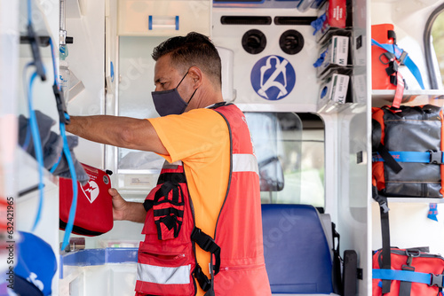 Photos Doctor using equipment inside an ambulance