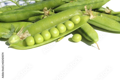 On a white background lie several pods of green peas with peas.