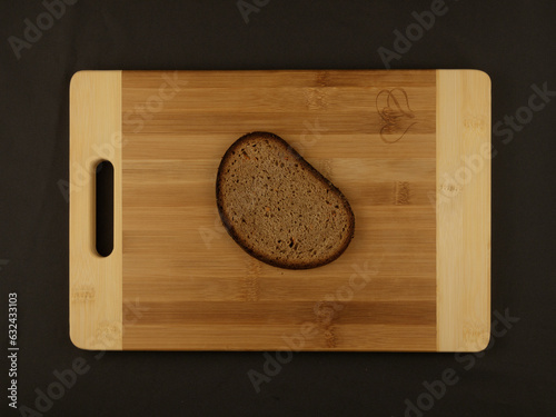 A real slice of rye carrot bread on a board with a heart