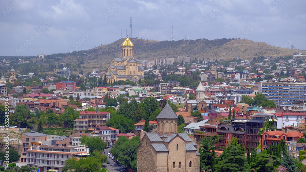 landscape old Town and houses of Tbilisi , Georgia from Above Narikala fort: Holy Trinity Cathedral, Tranquil Lake Views, Peace Bridge Charm, Nmetekhi St. Virgin Church Heritage Zion Cathedral Majesty