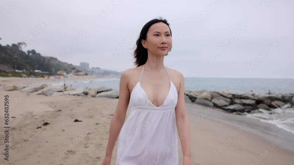 Attractive Asian woman running on the beach in Santa Monica California. Slow Motion. Attractive Asian woman running on the beach in Santa Monica California. Slow Motion.