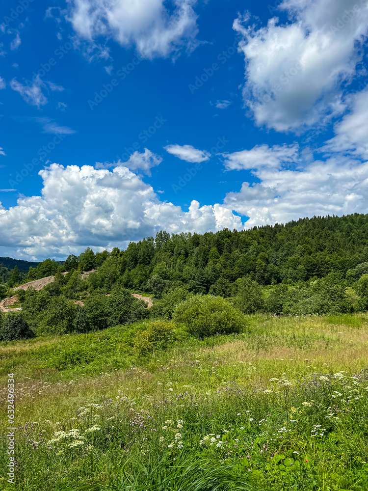 Awesome Carpathian mountains landscape background with forest and clouds on the summer season Awesome Carpathian mountains landscape background with forest and clouds on the summer season