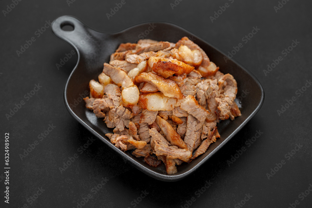 tasty sliced grill beef fillet steak meat in black skillet pan on dark tone texture background tasty sliced grill beef fillet steak meat in black skillet pan on dark tone texture background
