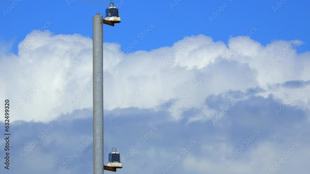 Fast moving layered clouds with derelict metal post in foreground. Time lapse 30x. Fast moving layered clouds with derelict metal post in foreground. Time lapse 30x.