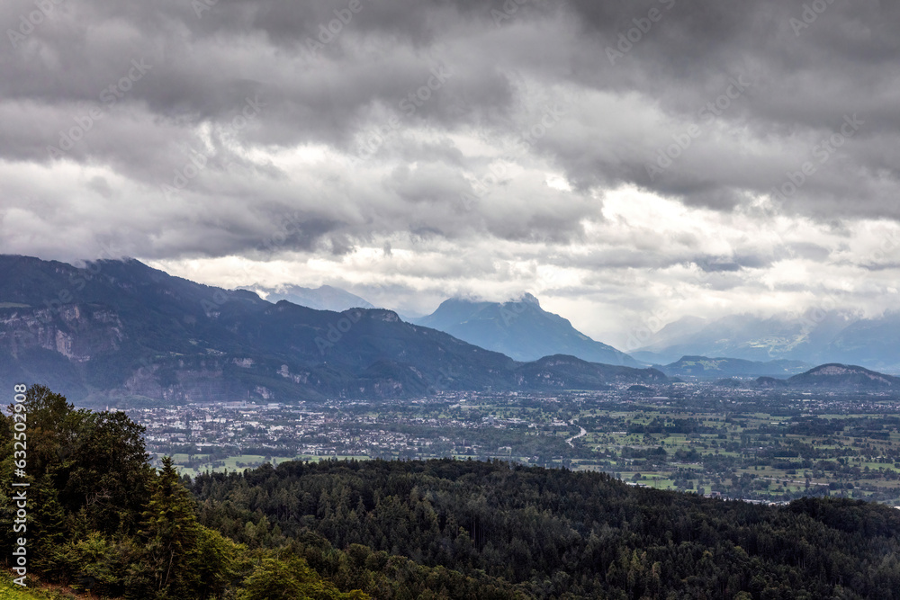 View at Bregenz and surrounding towns and mountains from mount Pfänder, a local mountain in austria at a rainy day in summer