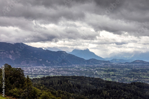 View at Bregenz and surrounding towns and mountains from mount Pfänder, a local mountain in austria at a rainy day in summer