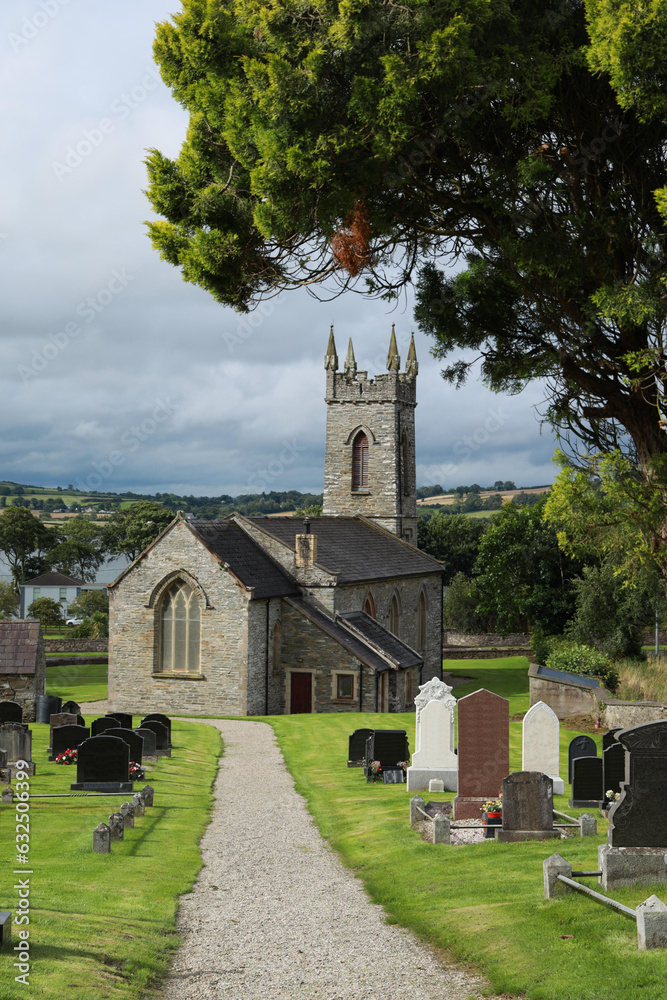 Fototapeta premium St Mura's Parish Church, a 19th century Church of Ireland church pictured here in summertime sunlight. Fahan, County Donegal, Ireland