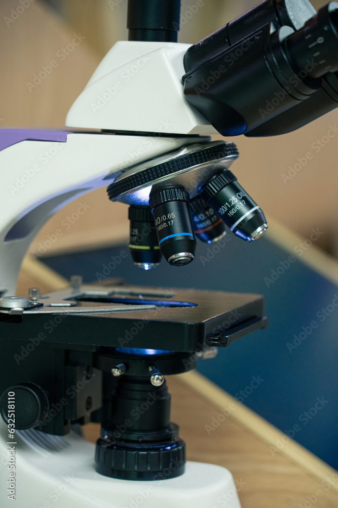 Microscope close-up in the laboratory using metal lenses.