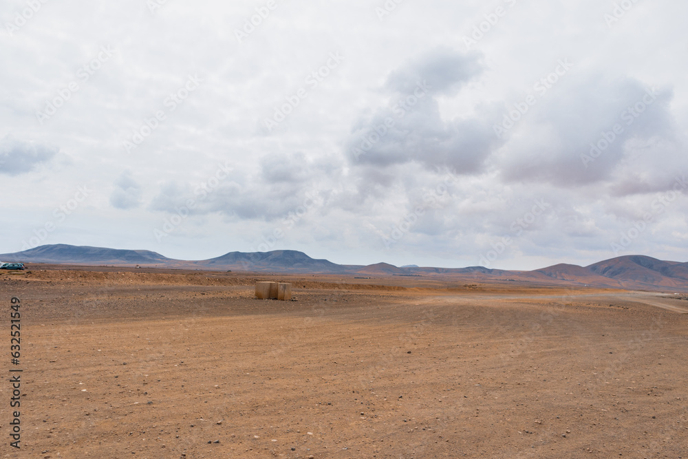 Desert landscape of white sand with big white clouds in the sky. Fuerteventura, Canary Islands, Spain Desert landscape of white sand with big white clouds in the sky. Fuerteventura, Canary Islands, Spain