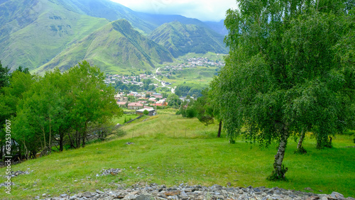 A View to Infinity: The Kazbegi Mountains Rise Above the Clouds, surrounding the small town of Kazbegi Mkinvartsveri in Georgia in a cloudy day in summer, Gudauri gergeti trinty church, ananuri