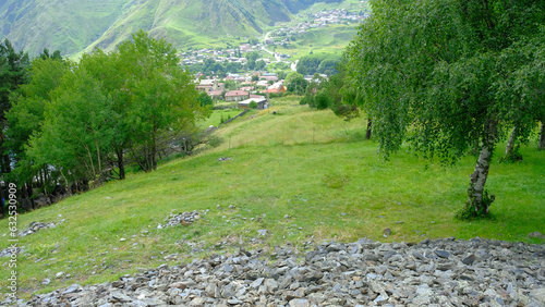 A View to Infinity: The Kazbegi Mountains Rise Above the Clouds, surrounding the small town of Kazbegi Mkinvartsveri in Georgia in a cloudy day in summer, Gudauri gergeti trinty church, ananuri