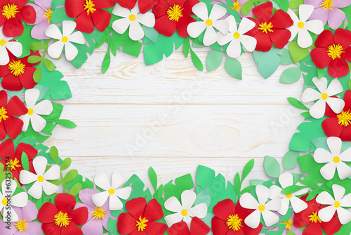 Composition of cut paper tropical palm leaves, Monstera, banana leaves, flowers. Handmade nature mockup, summer art collection on white wooden background. Floral frame. Top view, flat lay, close up