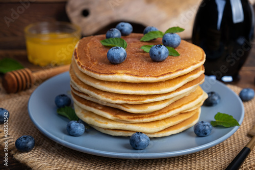 Delicious pancakes with blueberries and honey. Sweet pancakes with fresh berries