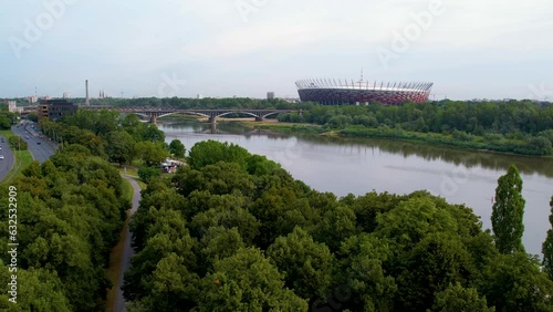 Aerial View of Poniatowski Bridge Over Vistula River and PGE Narodowy National Stadium in Praga district of Warsaw On Summer Day  photo