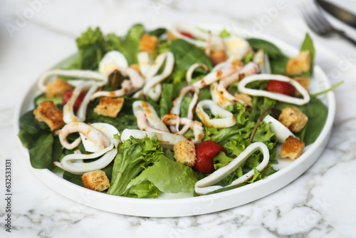 Leaf salad with grilled squid and croutons