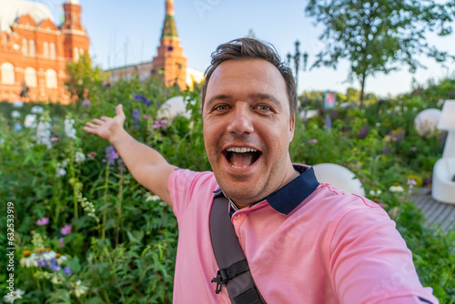 Carefree mature man taking selfie on background of State historical museum at Red Square in summer