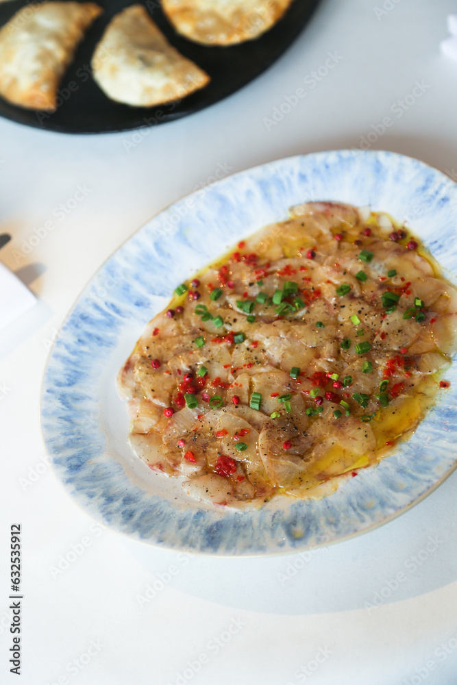 White fish appetizer with pepper and spring onion White fish appetizer with pepper and spring onion