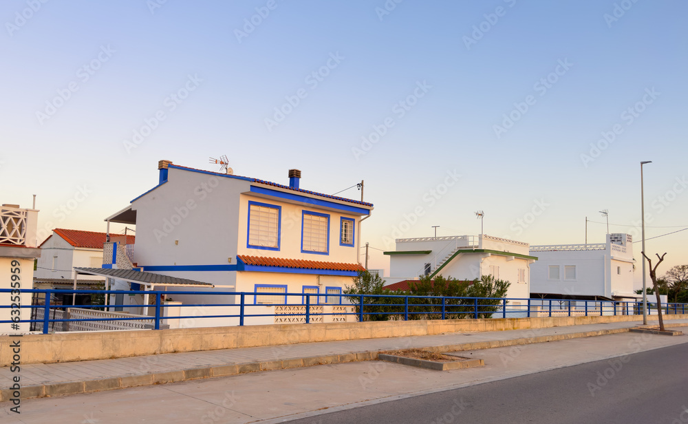 House at sea with pavement road. Suburb house building Exterior. Villa at seaside for holiday. Facade of house with Garden. House Exterior at coast. Residential home building for vacation on sea.