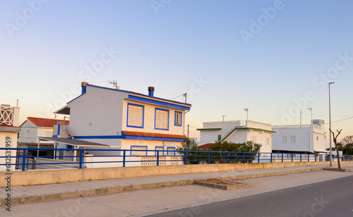 House at sea with pavement road. Suburb house building Exterior. Villa at seaside for holiday. Facade of house with Garden. House Exterior at coast. Residential home building for vacation on sea. © MaxSafaniuk