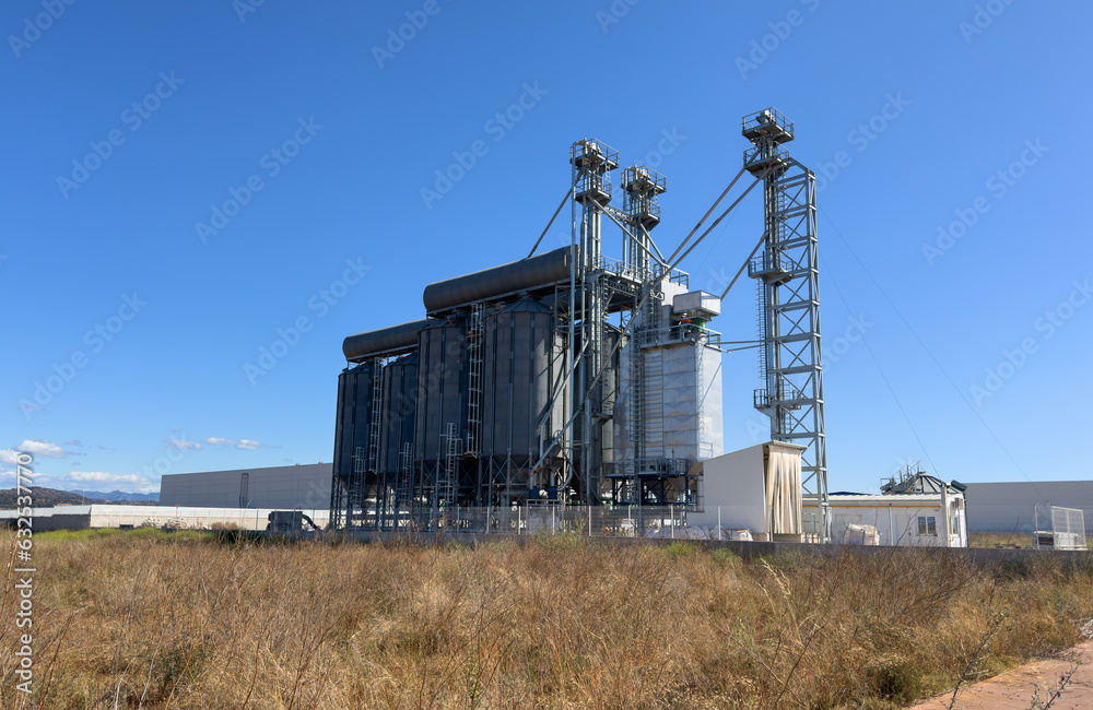 Grain storage. Silo at Agricultural farm. Wheat flour plant production in Spain. Elevator for corn storage. Feed Silos Hopper for wheat storage and barley. Wheat flour factory. Agriculture industry