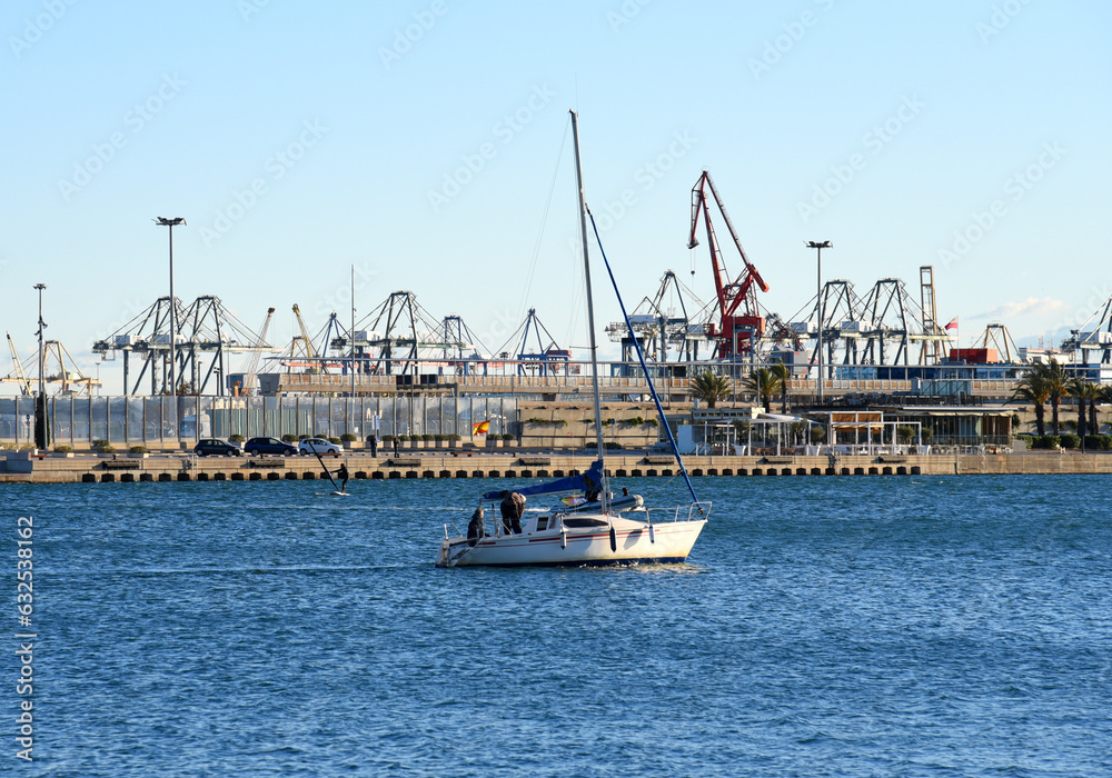 Fototapeta premium Yacht on sunset in Port Valencia . Yacht club at Mediterranean Sea. Skiff and Sailboat in harbour. Yachting and sailing sport. Yachts and catamaran in La Marina de Valencia, Spain. Luxury yachts