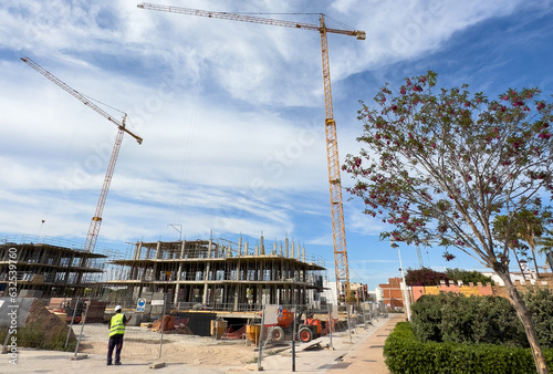 Tower cranes on formwork. Towhouse construction. Tower crane on construction site. Building Сonstruction. Construction of modern house. Home Build renovation in Spain, Sagunto. Housing project..