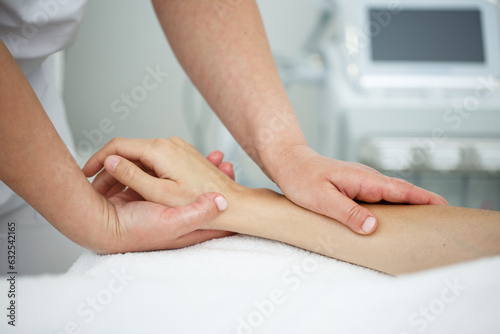 Close up massage of a woman's hands in the interior of a beauty salon on a white background