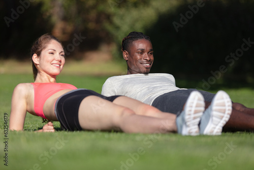 charming young girl and slender muscular man doing plank