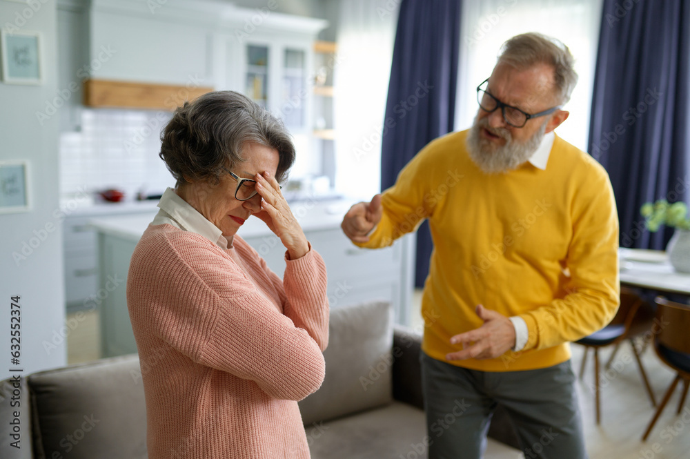 Angry elderly husband shouting on elderly upset wife Angry elderly husband shouting on elderly upset wife