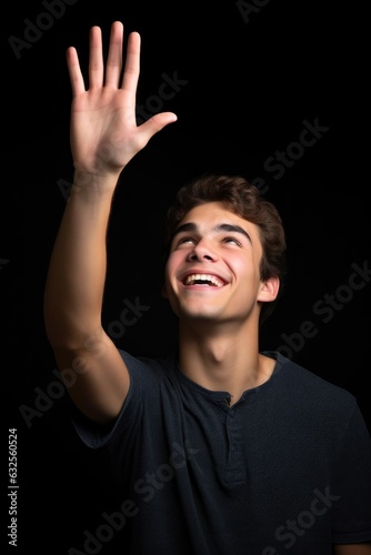 studio shot of a young man holding up copyspace
