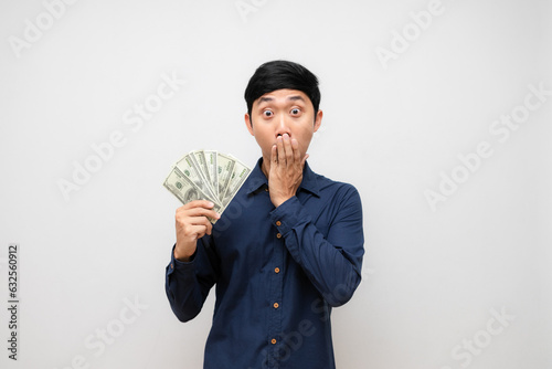 Asian young man feels excited about earn a lot of money in his hand isolated
