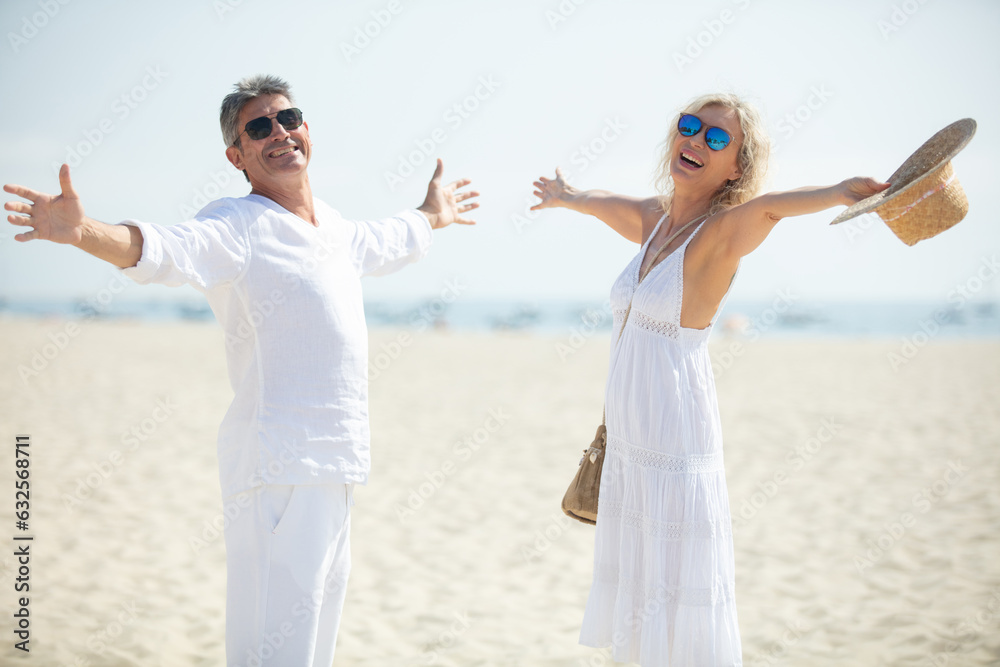 happy couple laughing together at the beach happy couple laughing together at the beach