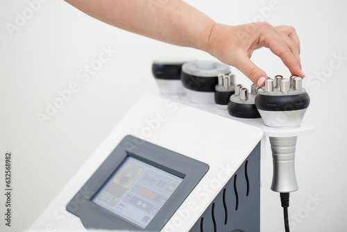 RF body cavitation lifting procedure in a beauty salon. Ultrasound therapy to reduce fat and elasticity of the skin. Cosmetic ultrasonic anti-cellulite massage close-up