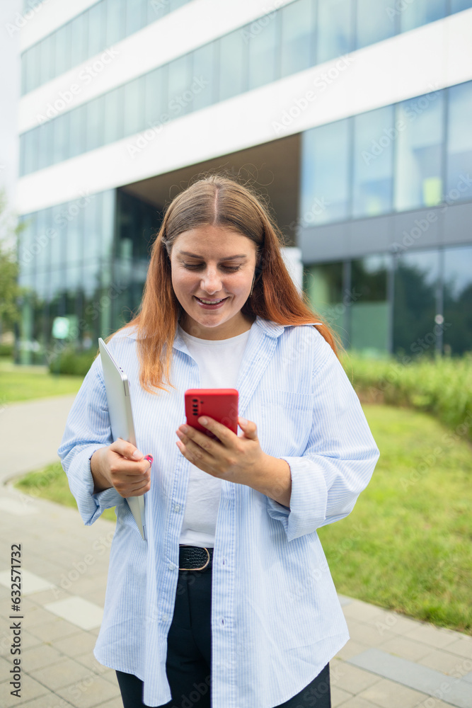 Happy business woman holding a digital tablet reading a text message on her phone while commuting to work in the city. High quality photo Happy business woman holding a digital tablet reading a text message on her phone while commuting to work in the city. High quality photo