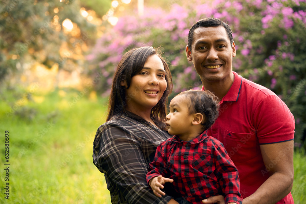 A beautiful family in a park with a one-year-old child A beautiful family in a park with a one-year-old child
