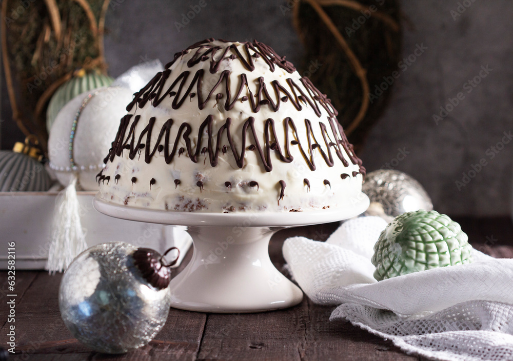 Pancho cake made of chocolate biscuit with sour cream and pineapple in New Year's or Christmas decoration. Rustic style.