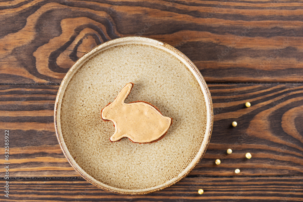 Homemade gingerbread in the form of a rabbit with honey, cinnamon and spices in a bowl.