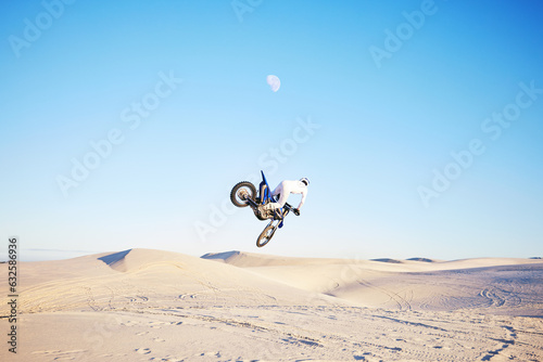 Desert, motorbike jump or sports person travel, agile or driving on off road adventure, air freedom or bike journey. Motorcycle challenge, blue sky or extreme action driver, talent and skill training