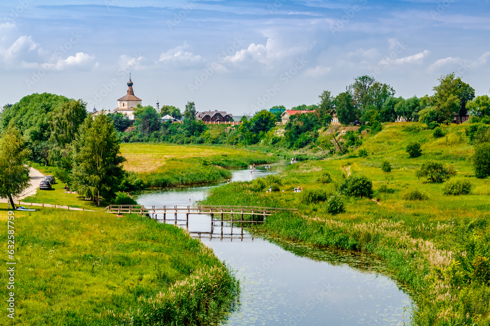Picturesque summer view of the rural side of Suzdal and the river Kamenkal.The Golden Ring of Russia. Picturesque summer view of the rural side of Suzdal and the river Kamenkal.The Golden Ring of Russia.