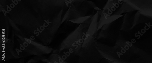 Black wrinkled paper texture, crumpled and folded black paper texture for background, black crumpled paper texture in low light background, template design.