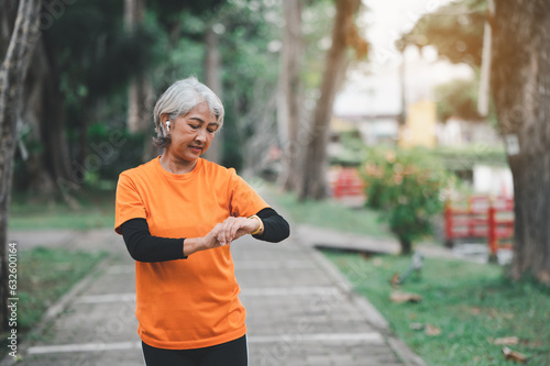 white-haired elderly person exercising in the park early in the morning.