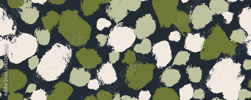 Grunge abstract spots and blots seamless pattern in green colors. Dalmatian skin print or camouflage. Hand drawn round brush strokes with rough edges. Vector decorative wrapping paper design.
