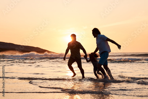 Lgbt family on beach, men and child holding hands at sunset, running in waves and island holiday together. Love, happiness and sun, gay couple on tropical ocean vacation with daughter in silhouette.