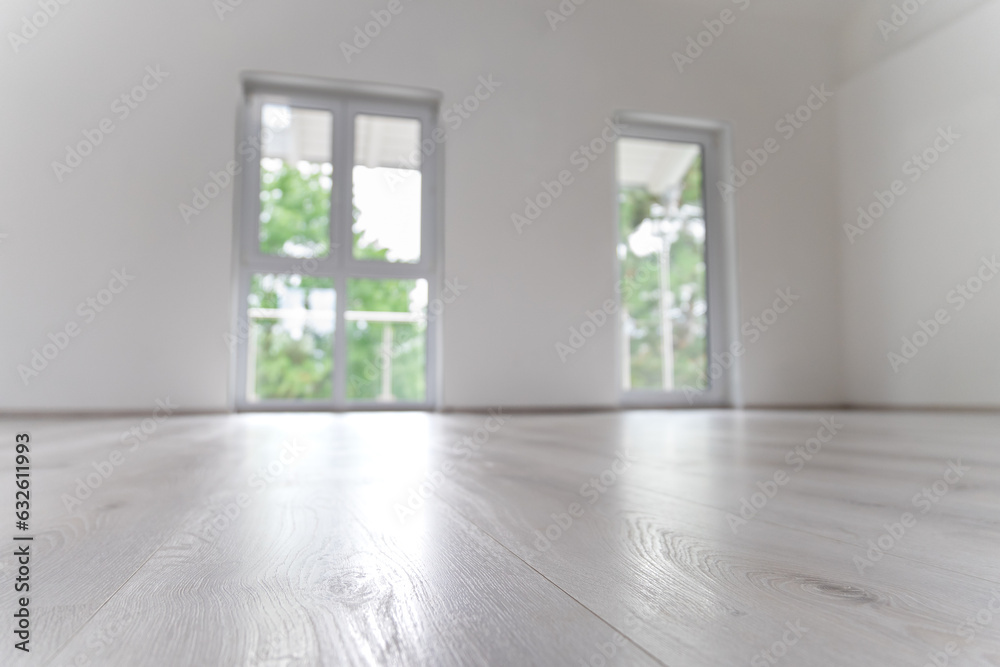 Obraz premium White, empty, modern living room with windows. Ready to move in. The product can be placed. Selected focus