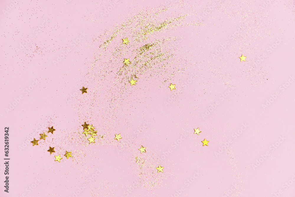Golden glitter sequins and stars on a pink background. Universal festive background. Horizontal, flat lay, Place under the text