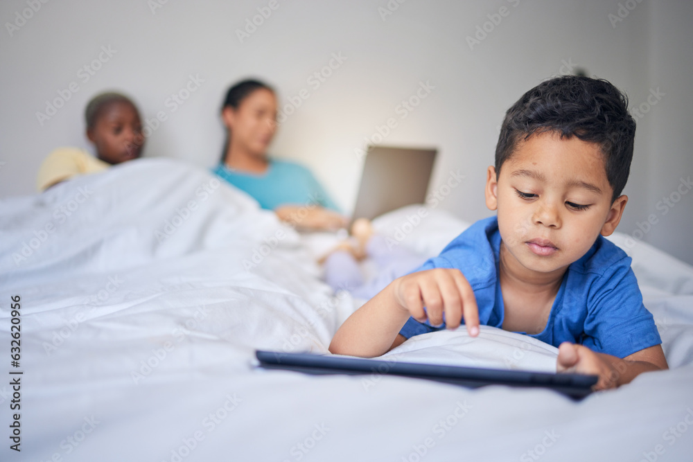 Children, tablet and education with a family in bed in the morning to relax together at home. Kids, technology and child development with a little boy in the bedroom to play a fun online game Children, tablet and education with a family in bed in the morning to relax together at home. Kids, technology and child development with a little boy in the bedroom to play a fun online game
