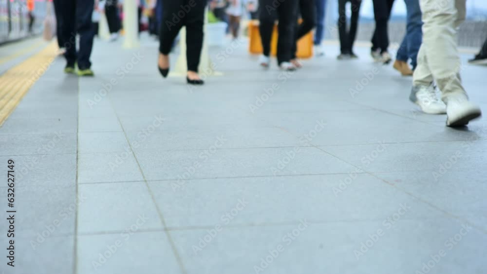 The legs of commuter train passengers are seen stepping closer after getting off the train at station in Jakarta city in the afternoon. Depicting the crowds of train passengers during work hours. The legs of commuter train passengers are seen stepping closer after getting off the train at station in Jakarta city in the afternoon. Depicting the crowds of train passengers during work hours.