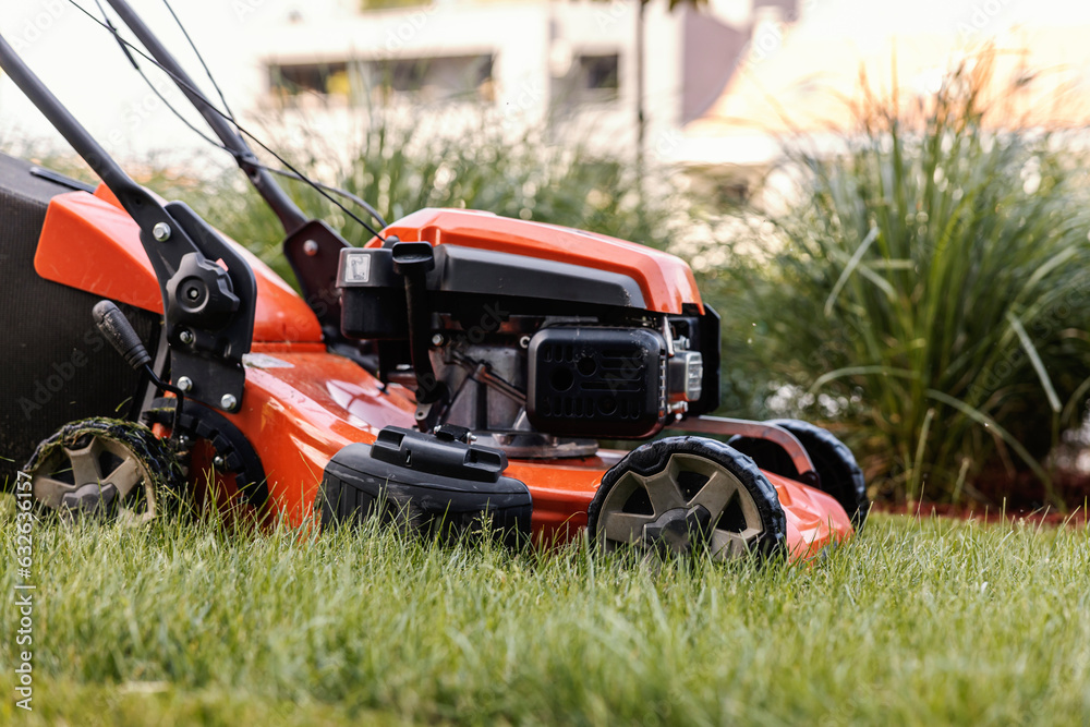 Close up picture of a lawn mower cutting grass.