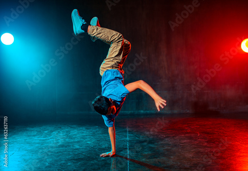 Photography Boy breakdancing in dark studio with lights